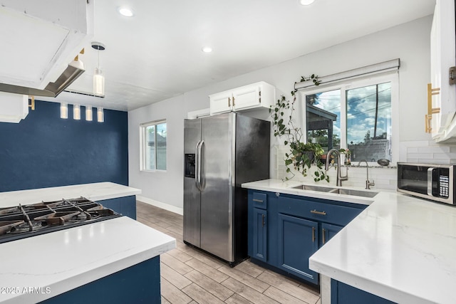 738 S Pomeroy, Mesa, AZ 85210 - kitchen with blue cabinetry, appliances with stainless steel finishes, a sink, backsplash, and extractor fan