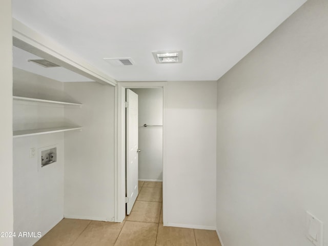 clothes washing area with light tile patterned floors and washer hookup
