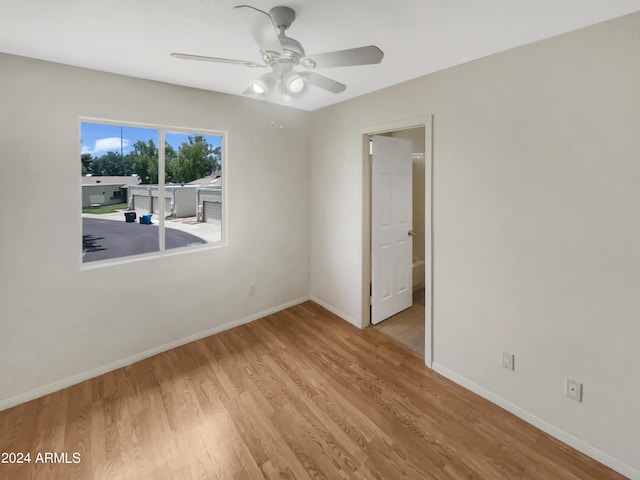 unfurnished room with light wood-type flooring and ceiling fan