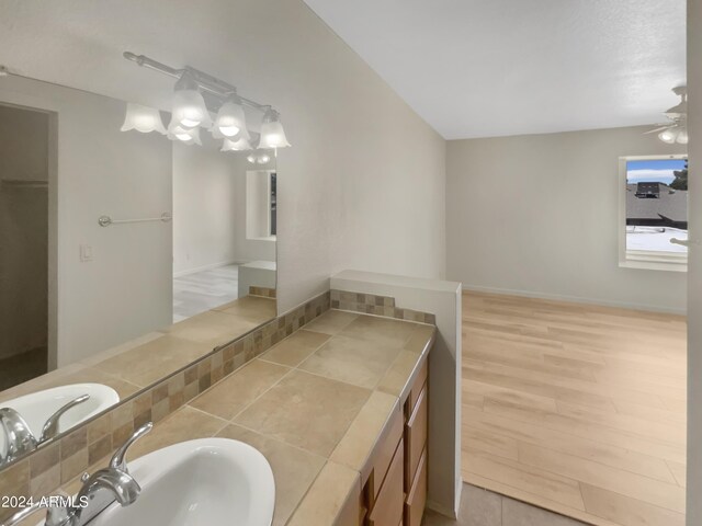 bathroom featuring ceiling fan, sink, and hardwood / wood-style floors