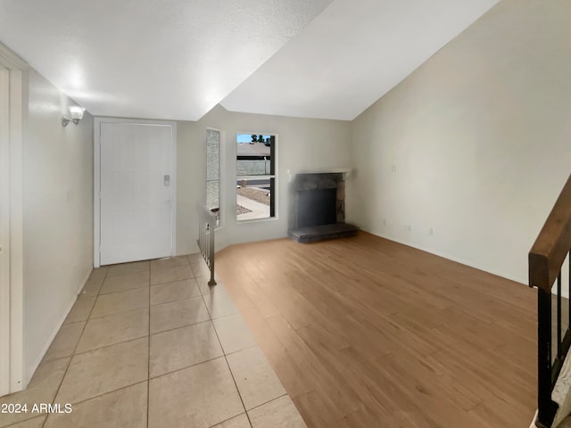 bonus room featuring lofted ceiling and light wood-type flooring