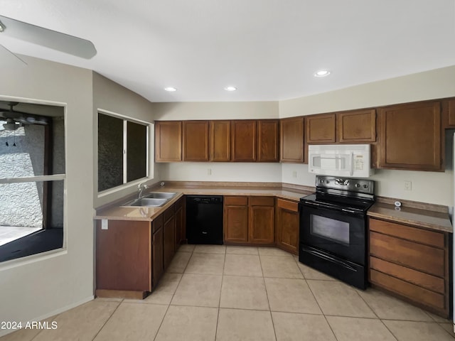 kitchen featuring sink, black appliances, and light tile patterned floors
