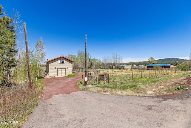 1551 Mormon Lake Rd, Mormon Lake, AZ 86038 - view of yard featuring fence, a view of countryside, an outbuilding, and dirt driveway