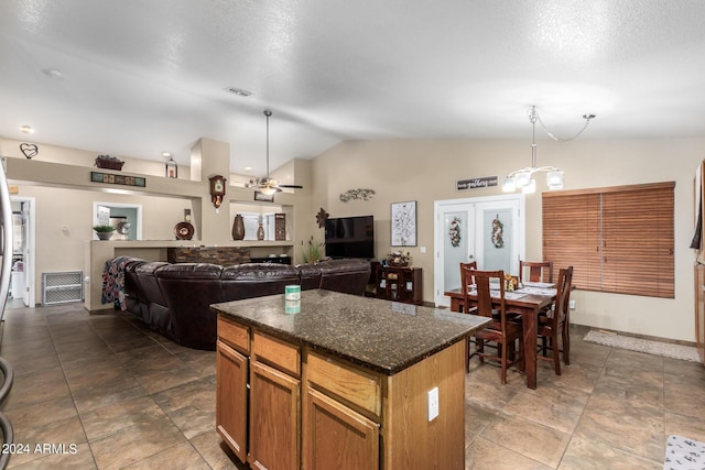1147 N Marvin St, Gilbert, AZ 85233 - kitchen with vaulted ceiling, a center island, pendant lighting, a chandelier, and ceiling fan