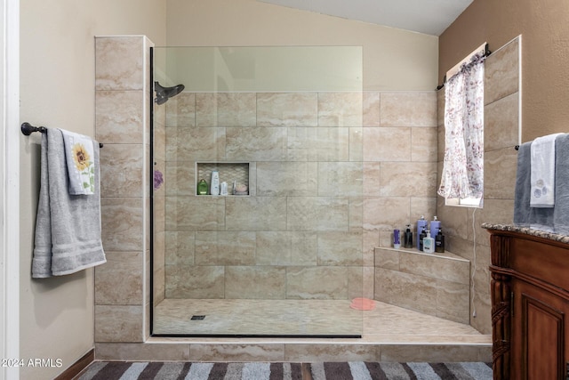 1147 N Marvin St, Gilbert, AZ 85233 - full bathroom with tiled shower, vanity, and lofted ceiling