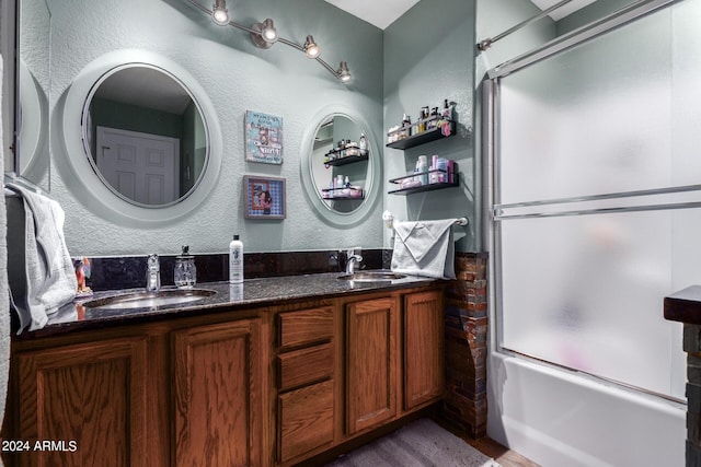 1147 N Marvin St, Gilbert, AZ 85233 - full bath with a textured wall, double vanity, enclosed tub / shower combo, and wood finished floors