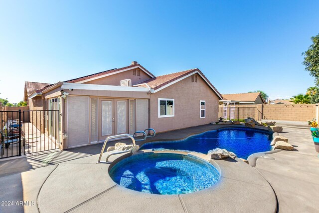 1147 N Marvin St, Gilbert, AZ 85233 - view of swimming pool featuring french doors, a fenced backyard, a patio, a gate, and a pool with connected hot tub