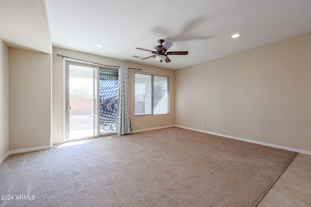 carpeted spare room with ceiling fan