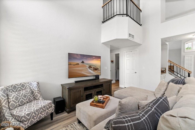 9056 E Maple Dr, Scottsdale, AZ 85255 - living room with wood finished floors, visible vents, a towering ceiling, and stairs