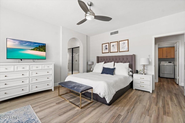 9056 E Maple Dr, Scottsdale, AZ 85255 - bedroom featuring wood finished floors, visible vents, arched walkways, ceiling fan, and washer / clothes dryer