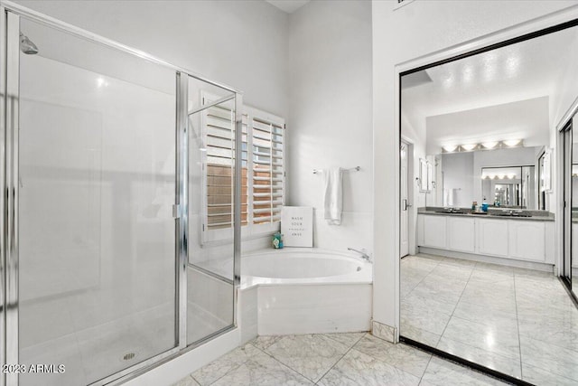 9056 E Maple Dr, Scottsdale, AZ 85255 - bathroom featuring a garden tub, marble finish floor, vanity, and a stall shower