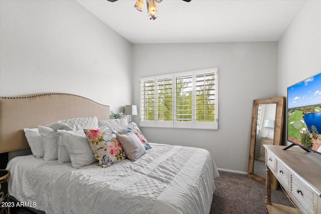 carpeted bedroom featuring vaulted ceiling and ceiling fan