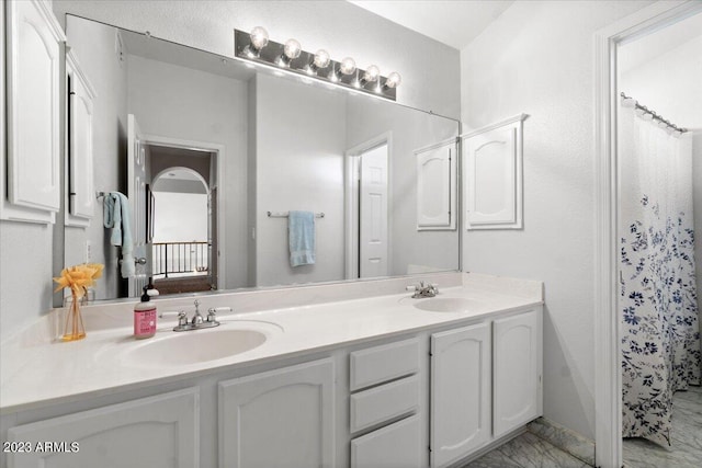 bathroom featuring vanity and a shower with shower curtain