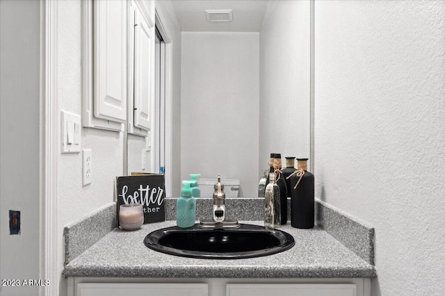 9056 E Maple Dr, Scottsdale, AZ 85255 - bathroom with a textured wall, vanity, and visible vents