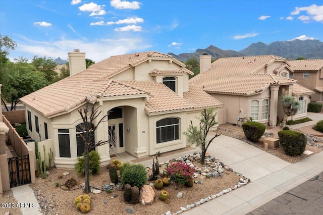 9056 E Maple Dr, Scottsdale, AZ 85255 - mediterranean / spanish house featuring a tiled roof, a gate, a chimney, concrete driveway, and stucco siding