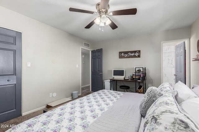 carpeted bedroom with ceiling fan and ensuite bathroom