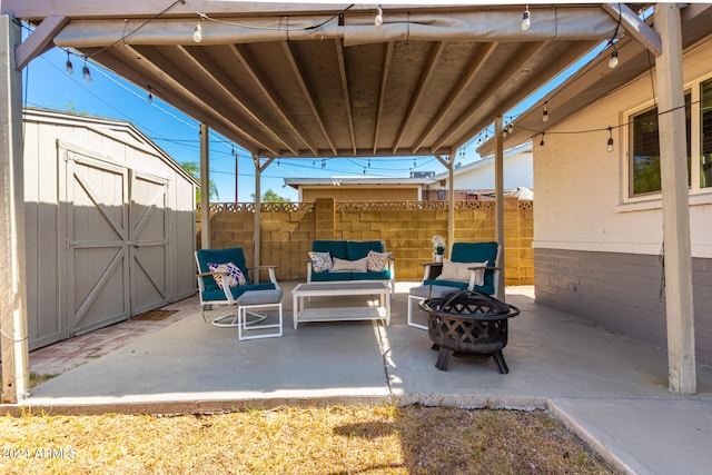 view of patio / terrace with a storage unit and an outdoor living space with a fire pit