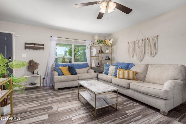 living room with wood-type flooring and ceiling fan