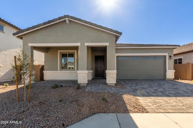 view of front of property featuring covered porch and a garage