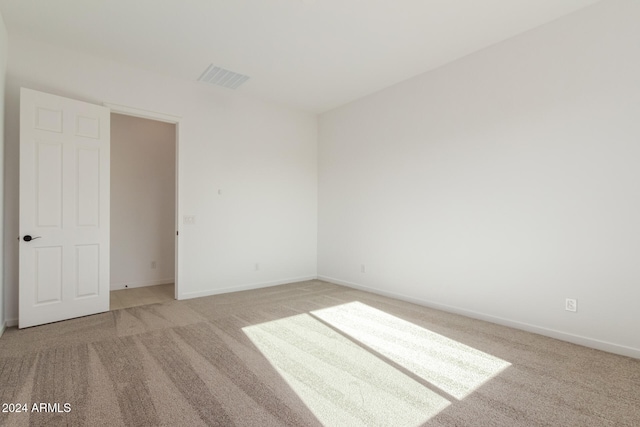 unfurnished room with light carpet