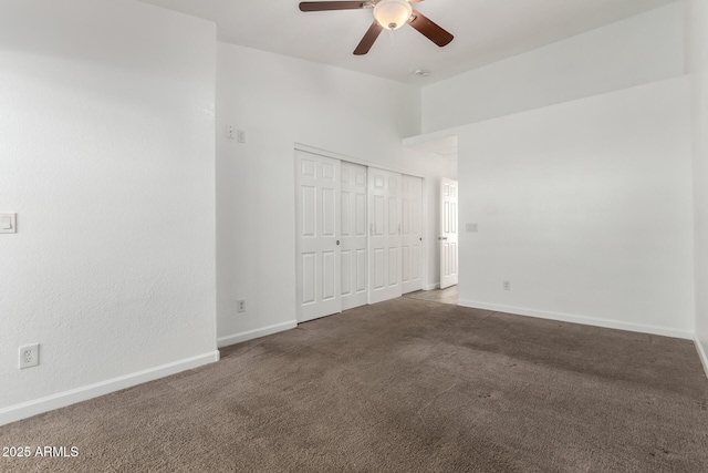 unfurnished bedroom featuring ceiling fan, carpet, and a closet