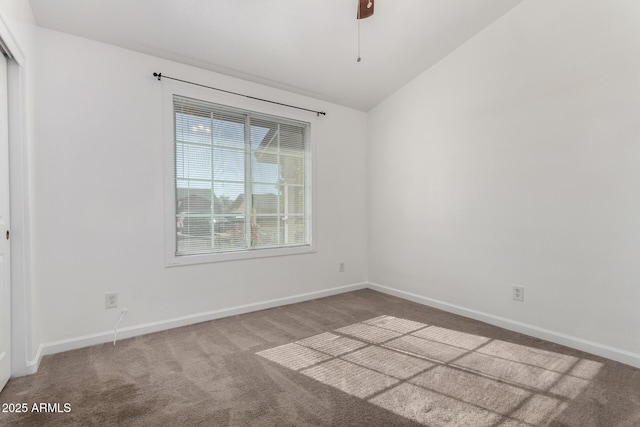 spare room featuring vaulted ceiling, ceiling fan, and carpet floors