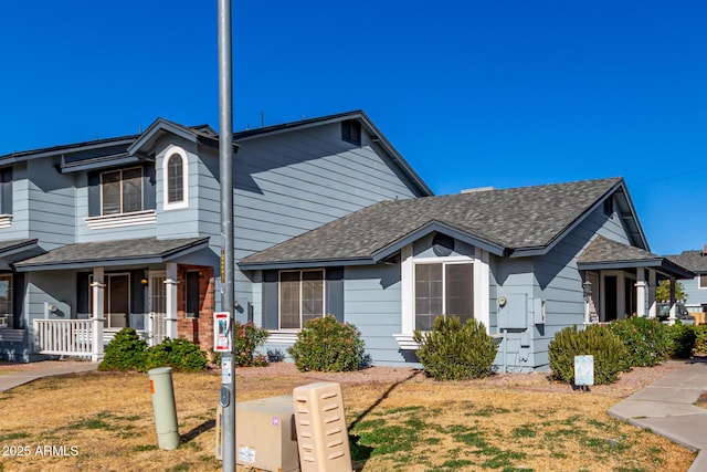 view of front of house featuring covered porch and a front lawn