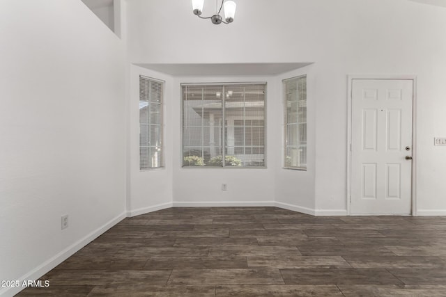 empty room featuring a chandelier and a high ceiling