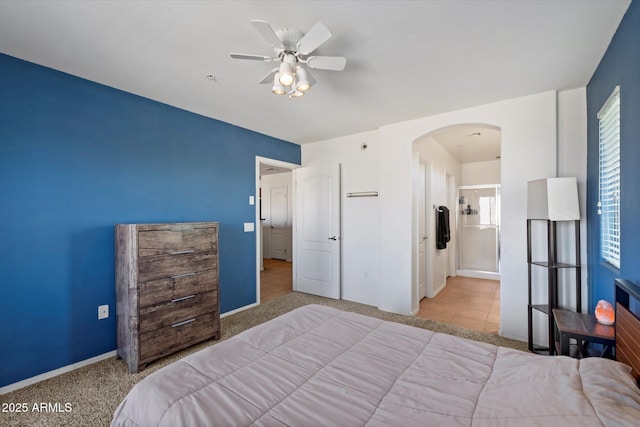 1350 S Greenfield Rd Unit 2133, Mesa, AZ 85206 - bedroom featuring arched walkways, carpet floors, baseboards, and a ceiling fan