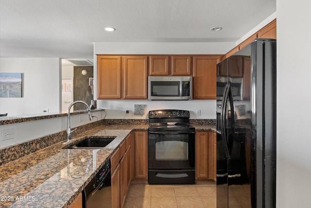1350 S Greenfield Rd Unit 2133, Mesa, AZ 85206 - kitchen featuring black appliances, a sink, brown cabinets, dark stone counters, and light tile patterned floors