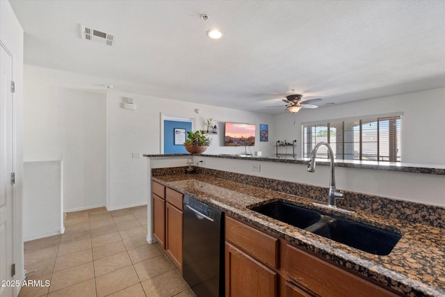 1350 S Greenfield Rd Unit 2133, Mesa, AZ 85206 - kitchen featuring dishwasher, a sink, brown cabinetry, dark stone countertops, and ceiling fan