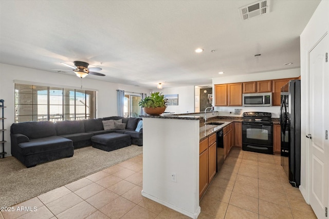 1350 S Greenfield Rd Unit 2133, Mesa, AZ 85206 - kitchen featuring black appliances, a sink, open floor plan, brown cabinets, and light tile patterned floors