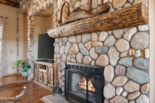 2259 Whitetail Ln, Prescott, AZ 86301 - details featuring baseboards, wood finished floors, and a warm lit fireplace