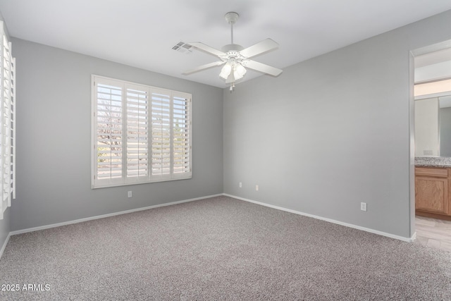 unfurnished room featuring ceiling fan and light carpet