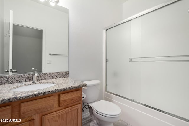 full bathroom featuring vanity, toilet, and combined bath / shower with glass door