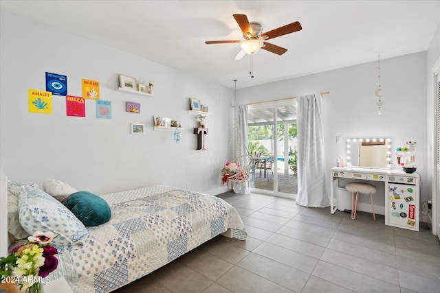 tiled bedroom with ceiling fan and access to outside