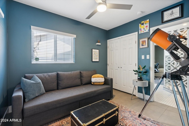 living room featuring ceiling fan and light tile floors