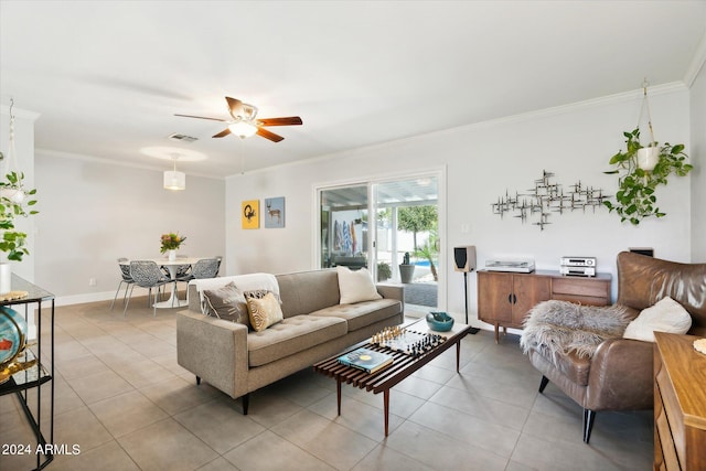 tiled living room with ceiling fan and ornamental molding