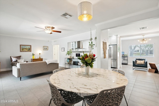 dining space featuring crown molding, ceiling fan with notable chandelier, and light tile flooring