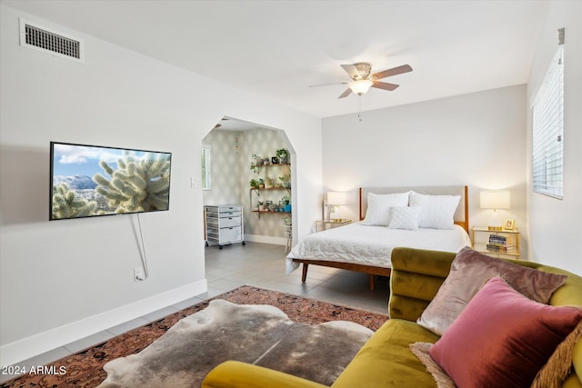 tiled bedroom with ceiling fan