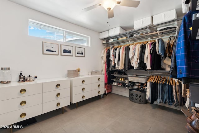 walk in closet with tile flooring and ceiling fan