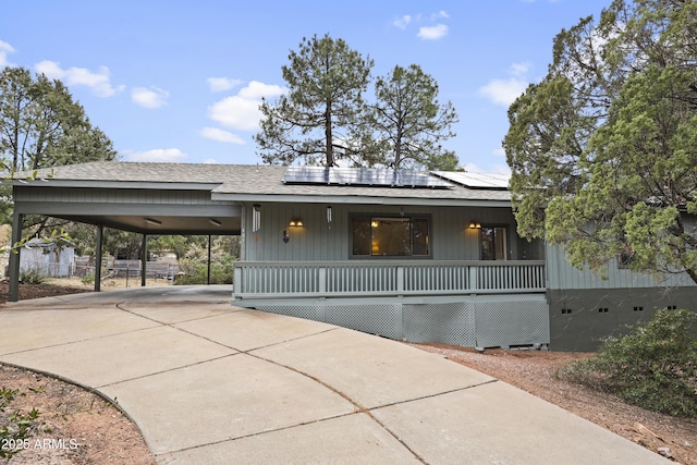 view of front of property featuring solar panels and covered porch