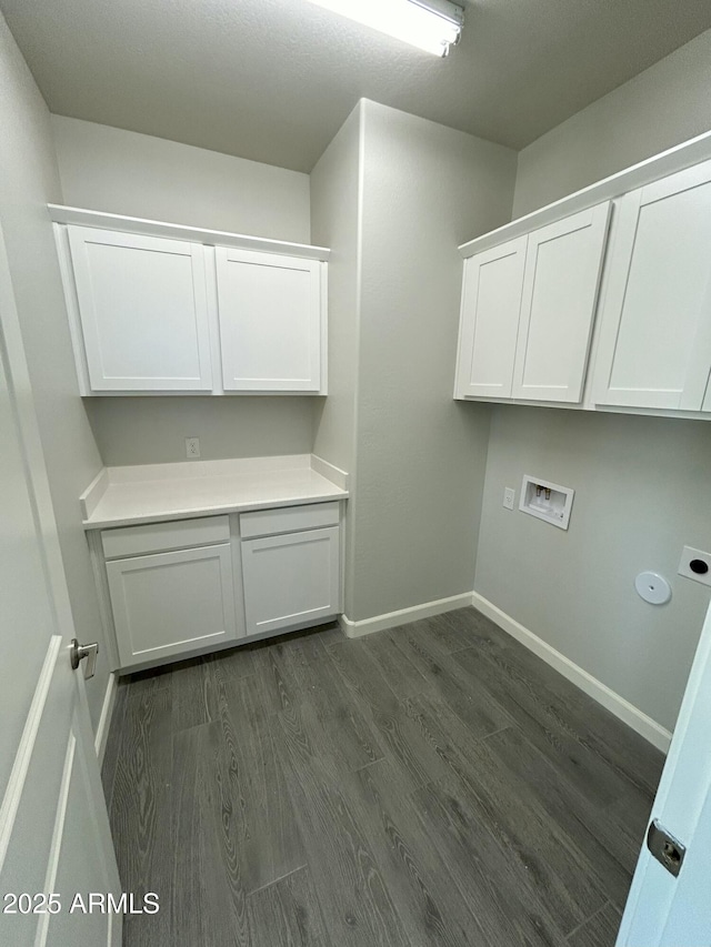 laundry area with cabinets, dark hardwood / wood-style flooring, hookup for an electric dryer, and hookup for a washing machine