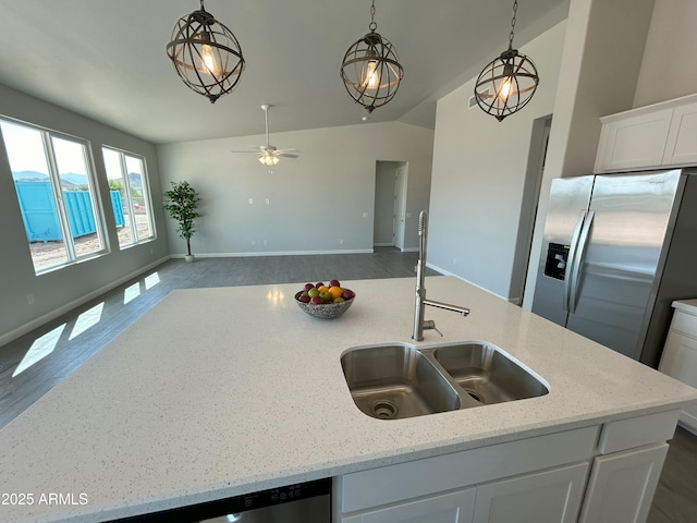 kitchen featuring white cabinetry, appliances with stainless steel finishes, sink, and light stone counters