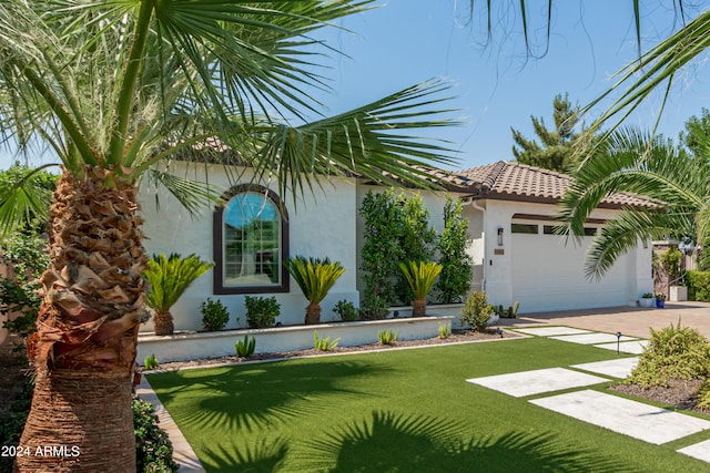 view of front facade with a front yard and a garage