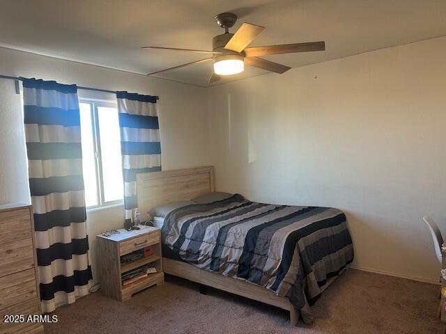 bedroom featuring multiple windows, ceiling fan, and carpet flooring