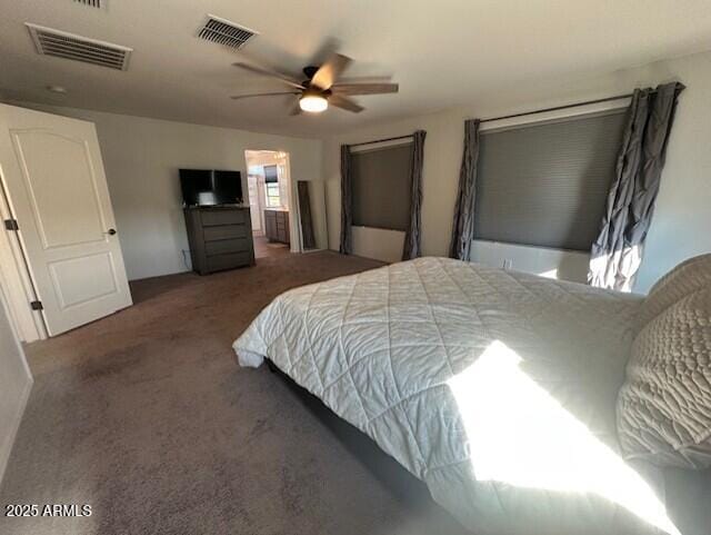 bedroom featuring ceiling fan and dark carpet