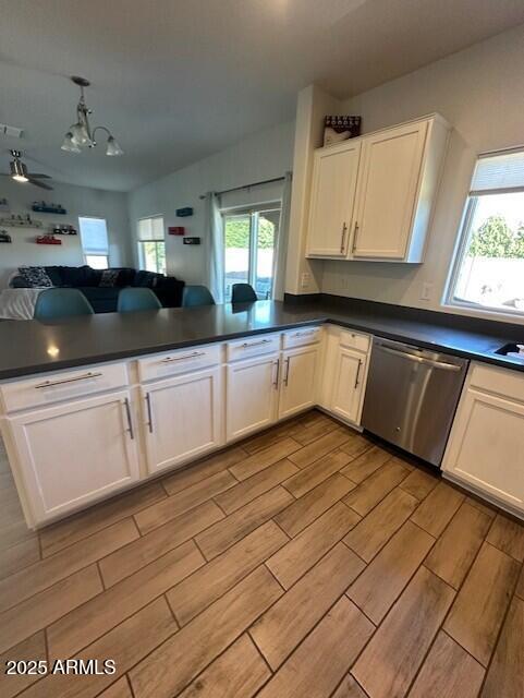 kitchen featuring white cabinets, ceiling fan with notable chandelier, kitchen peninsula, and dishwasher