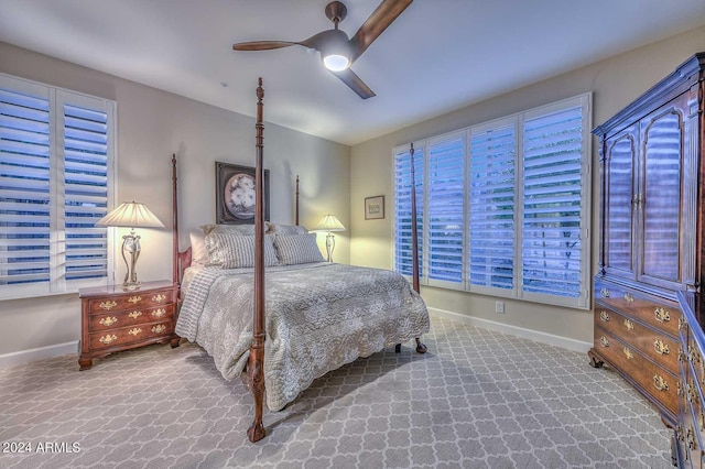 carpeted bedroom with a ceiling fan and baseboards