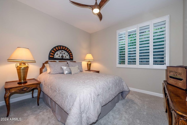 carpeted bedroom featuring baseboards and a ceiling fan